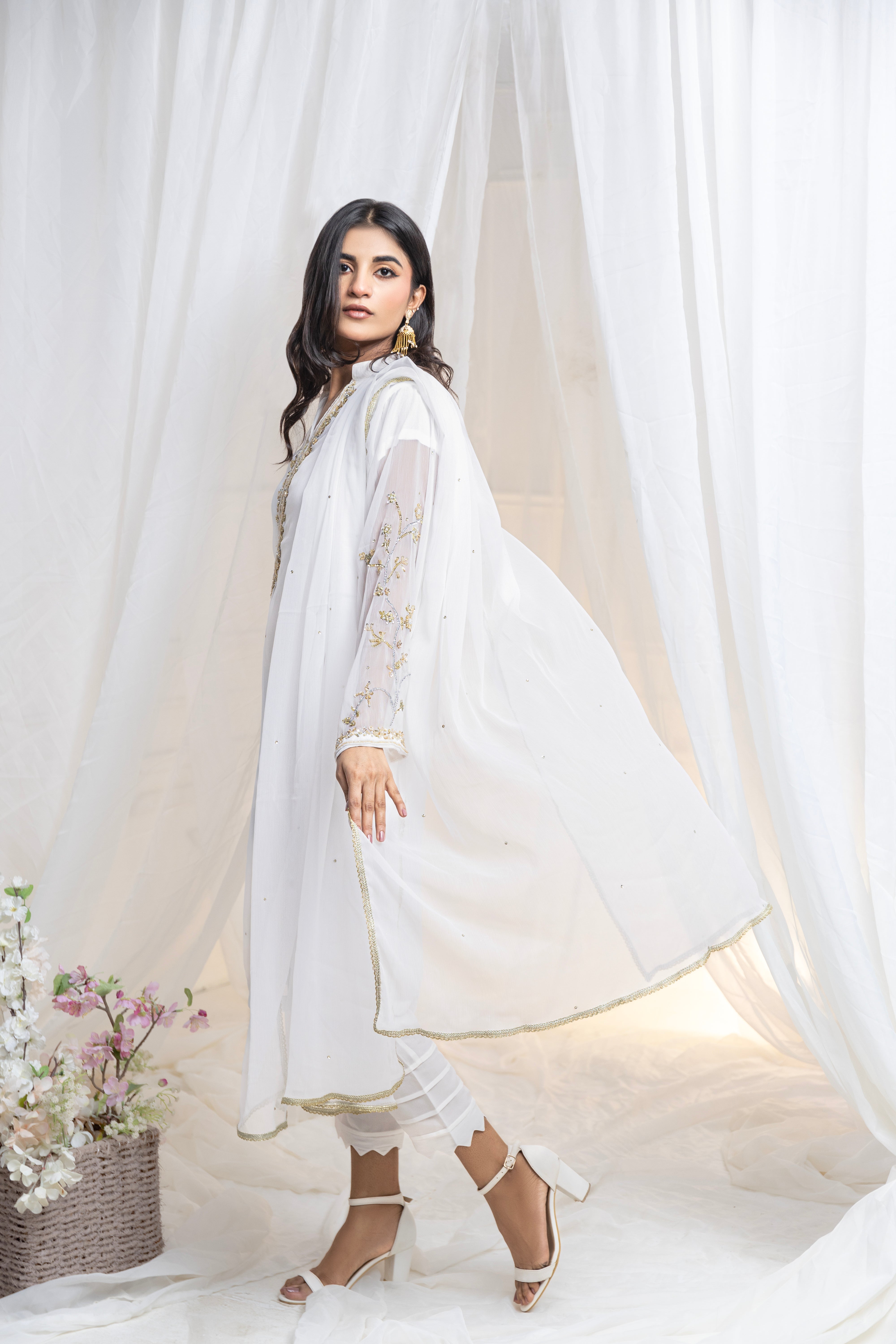 Untouched elegance: Hand-embroidered white chiffon, a canvas of pure sophistication.